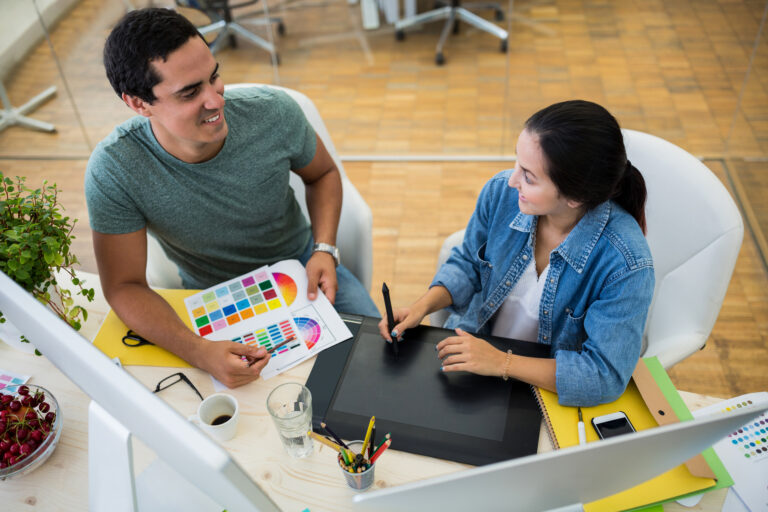 Male and female graphic designers interacting with each other