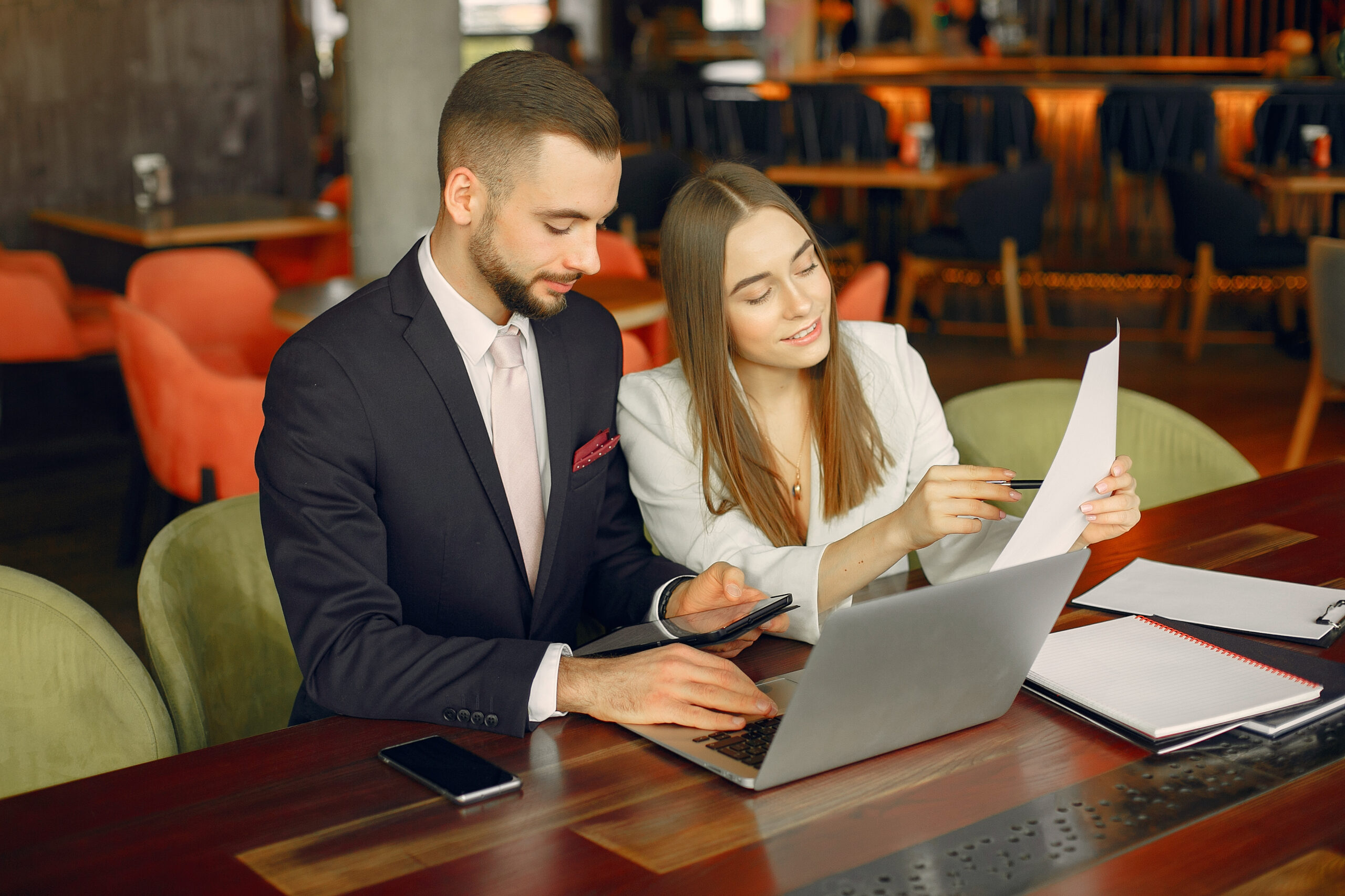 Partners sitting at the table and working in a cafe
