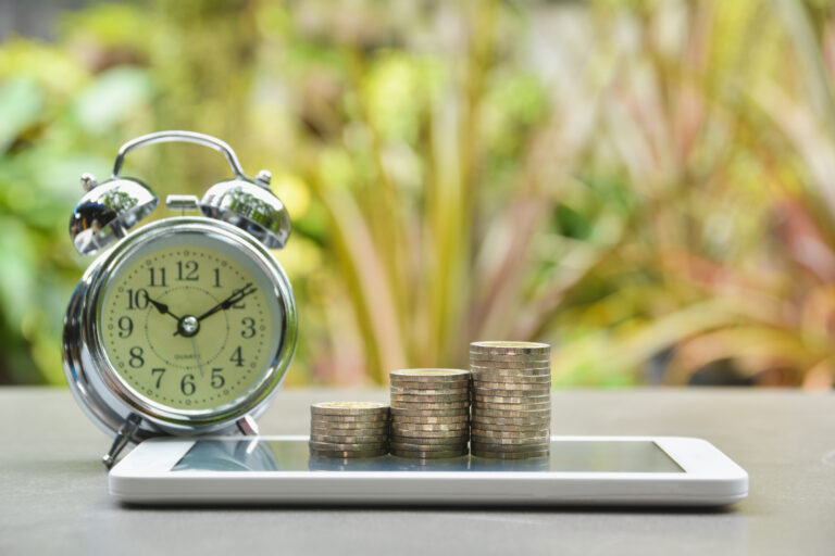 Saving money concept with money coin stack on smart-phone and al