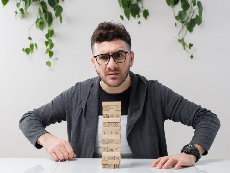 young-man-sitting-spectacles-watches-grey-jacket-angry-along-with-plant-white